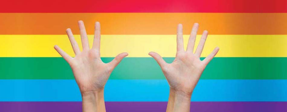 palms of human hands thumbs up over rainbow